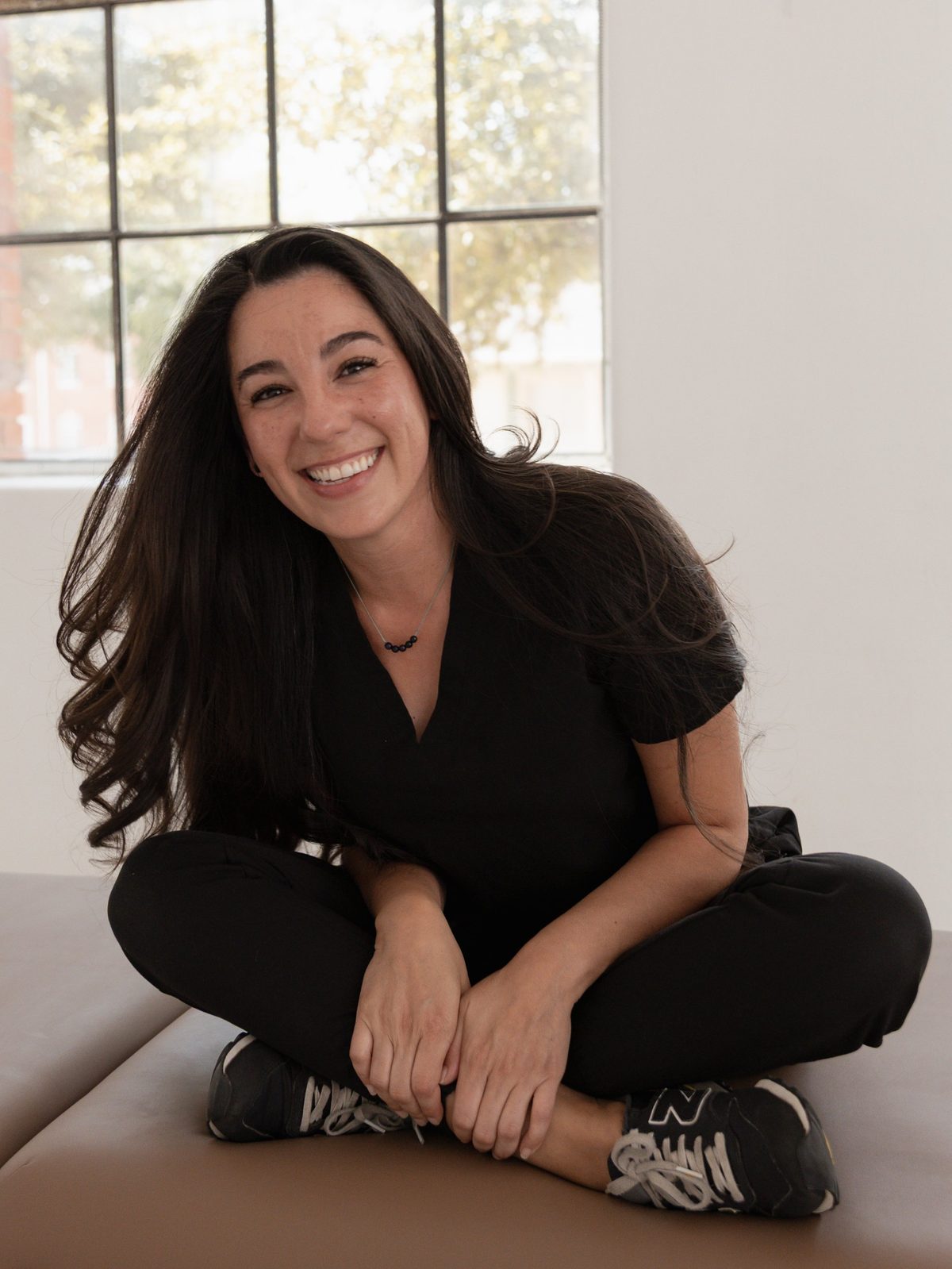 Valerie Vazquez smiling, seated in her studio